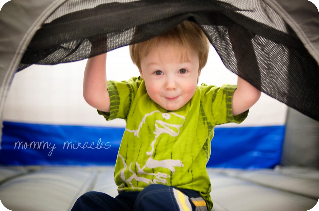 Cameron peeking out of the bouncy castle